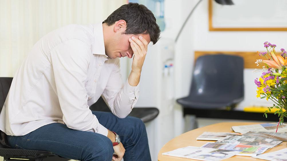 Exasperated man in doctor's waiting room.