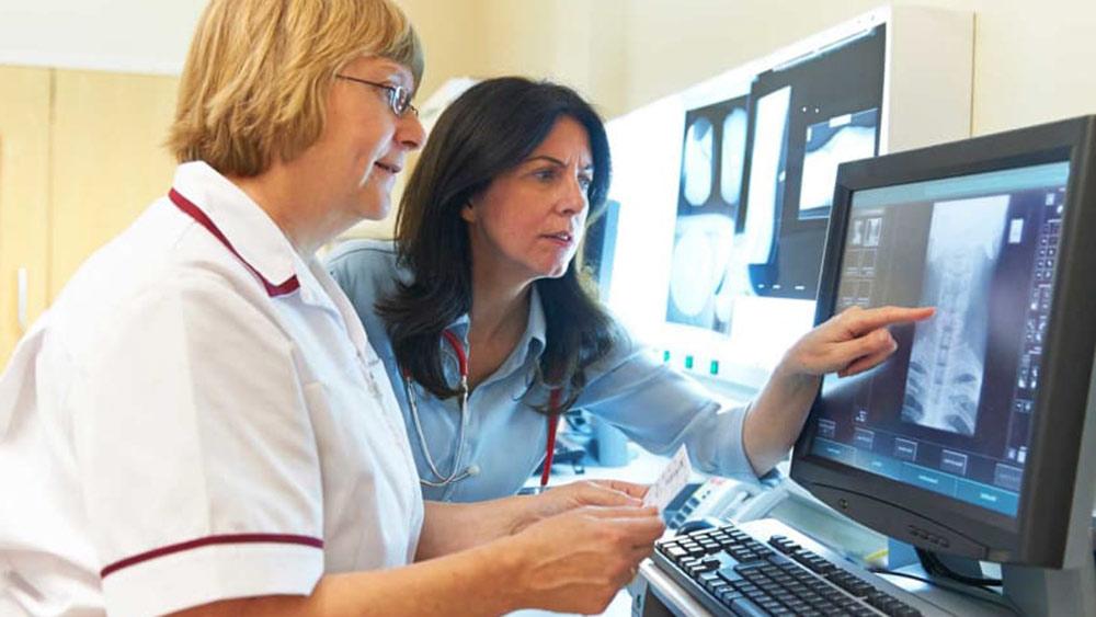 Two women looking at an x-ray.