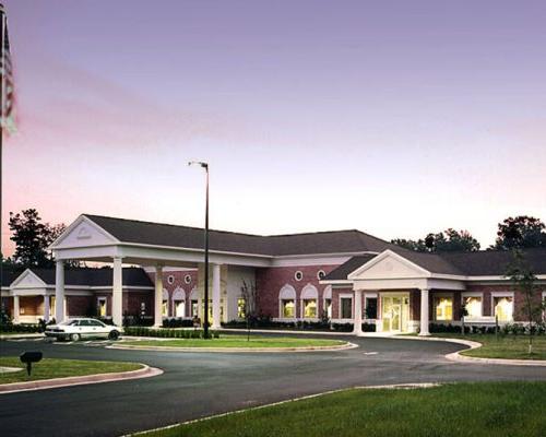 Exterior photo of Healthpark Hospital entrance at dusk.