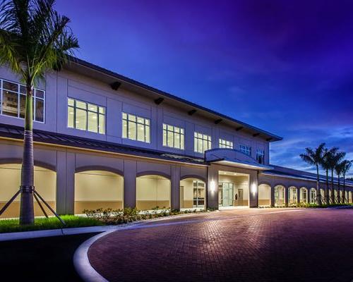 Exterior photo of LeeSar Regional Service Center at dusk. Red brick entry drive.